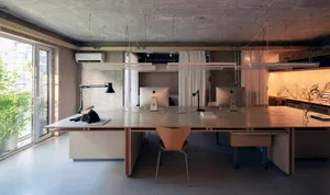 A modern industrial office space with concrete walls and minimalist design.