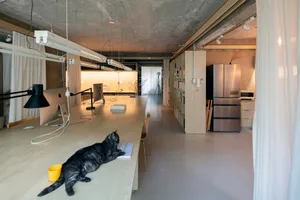 A modern workspace with industrial design elements and wooden surfaces.