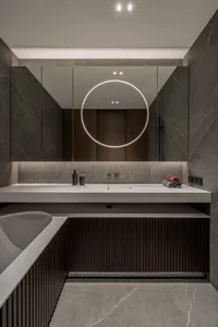 Contemporary bathroom with concrete and marble materials, featuring a minimalist design aesthetic.