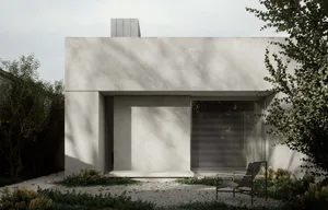 A minimalist concrete house with a modern exterior and metal chair in front of it.