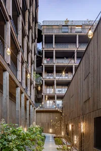 Modern residential architecture featuring wood exterior and balconies.