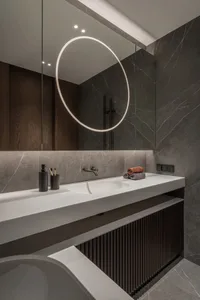 Modern bathroom featuring sleek marble tiles and a contemporary sink design.