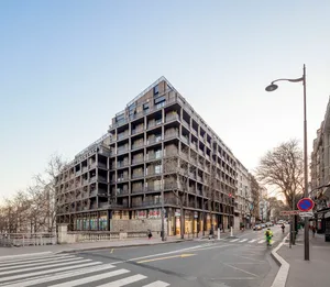 A modern building with a concrete facade and balconies.