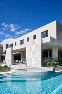 Modern residential home with concrete and glass exterior features.