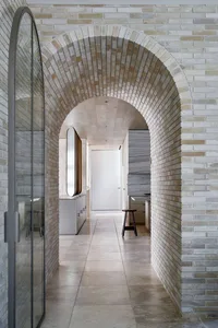 A modern interior with brick, concrete, and marble walls and flooring.