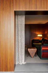 A modern living room with a warm wood texture, showcasing seamless integration of materials and design.