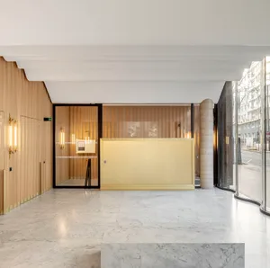 A modern lobby featuring marble finishes and light fixtures.