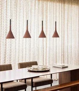 Modern dining room with wooden pendant lights and textured wall