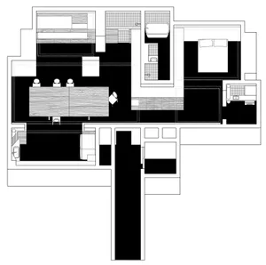A minimalist residential kitchen with black and white color scheme and wooden elements.