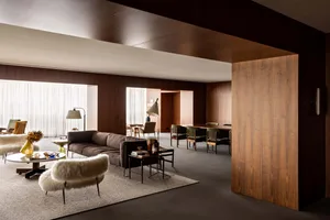 A modern living room with wooden walls, a cozy sofa, and minimalistic decor.