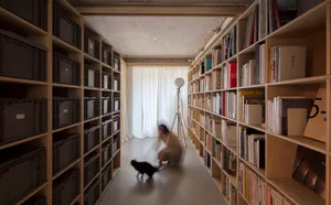A modern library with wooden bookshelves and metal wire containers.