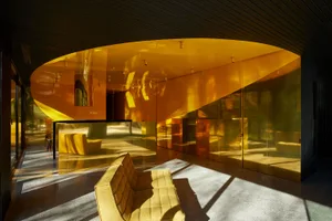 Modern living space featuring a golden metallic interior design.