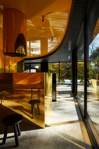 Modern interior space featuring a minimalist metal counter with a curved design.