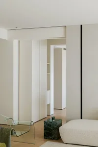 A modern interior design featuring white paneling in a living space.