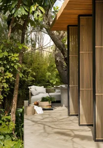 Modern, indoor lounge area with wooden materials and greenery.