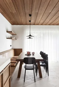 A modern interior design featuring wooden table and black chairs.