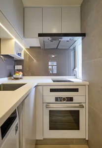 A modern residential kitchen featuring concrete countertops and flooring.