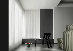 A modern minimalist living room with curtains, a black sculptural chair, and a white couch with vertical stripes.