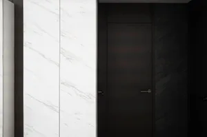A modern, minimalist doorway featuring a white marble wall and a dark wooden door.