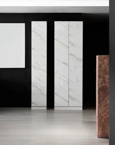 A minimalist storage unit with marble doors in a modern interior setting