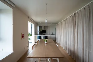 Modern dining room featuring a wooden table and minimalist decor.