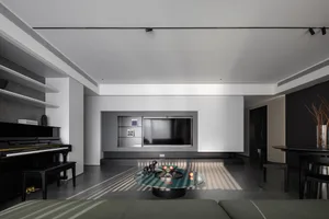 A modern living room featuring a black and white color palette, with minimalist furniture and metallic accents.
