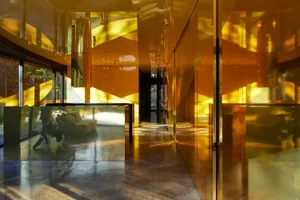Interior view of a modern office space featuring a minimalist metal wall design.