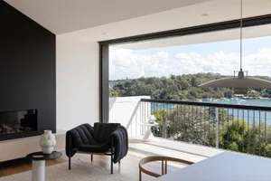 A modern minimalist living room featuring wooden elements.