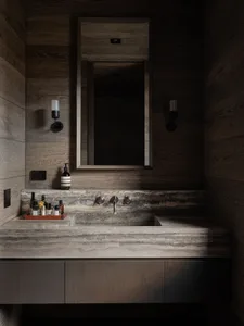 Modern industrial bathroom featuring a stone vanity counter and metal faucet fixtures.