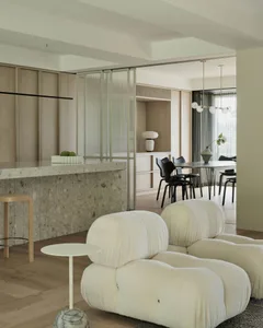 Modern interior design featuring a marble countertop and cozy, wool-textured sofa in minimalist living room setting