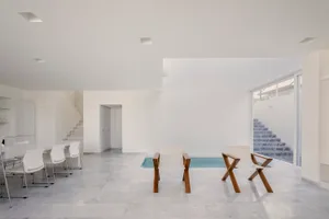 Minimalist living room with marble floor and pool area