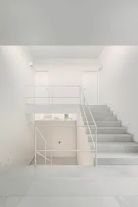 Modern concrete staircase in a minimalist white interior