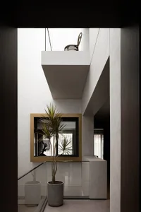 Modern living room with concrete walls and wooden furniture, featuring a minimalist design.