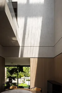 Modern residential interior with wooden finishes and glass elements.