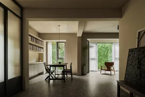 Modern industrial residential interior with minimalist design, concrete walls, and large windows.
