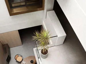 A minimalist living room featuring a concrete floor and modern furniture.