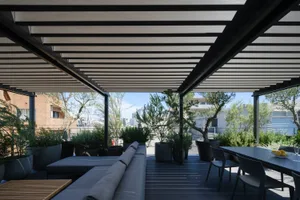 A modern minimalist roof deck featuring a wooden deck, outdoor furniture, and potted plants.