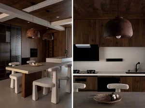 Modern kitchen with stone and concrete finishes, featuring a dining table and chairs.