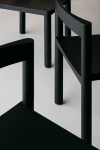 Detailed view of minimalist black wood furniture with clean lines and simple design.