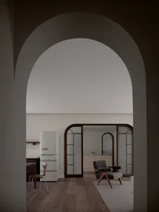 A modern minimalist living room featuring wooden furniture and glass walls.
