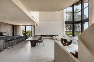 A modern residential kitchen with a concrete floor and minimalist design.