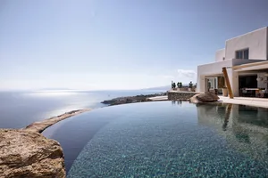 Modern vacation home overlooking the ocean with white-rendered walls, infinity pool, and sea view.