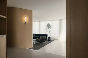 A modern living room with wooden walls and furniture.
