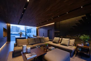 A modern living room with a gray sectional sofa and a coffee table with decorative items.