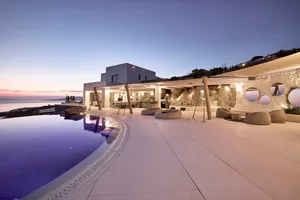 Modern residential patio featuring concrete, stone, and glass elements.