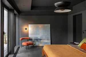 A modern bedroom featuring a concrete floor and minimalist design.
