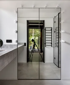 Modern bathroom interior with glass and concrete surfaces, minimalist design