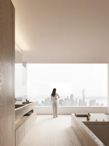 A minimalist bathroom with concrete flooring, a large window overlooking a city skyline, and a woman standing in front of it.