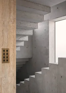 Modern concrete staircase with a window nearby