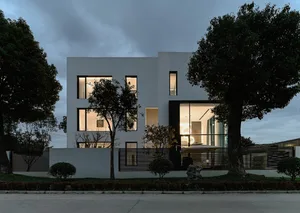 Modern residential exterior featuring a sleek, minimalist design with large windows and concrete finishing.
